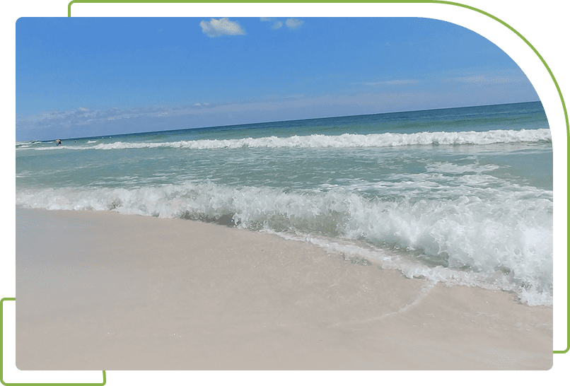 A beach with waves coming in from the ocean.